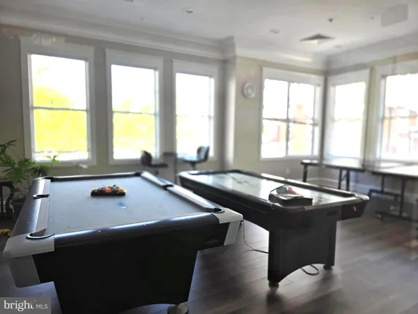 a room with furniture pool table and windows