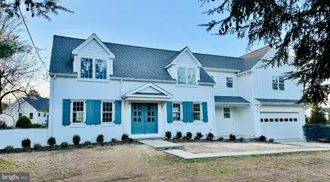 a front view of a houses with yard
