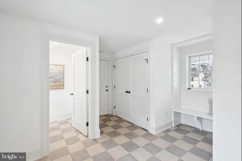 a view of a livingroom with wooden floor and a hallway
