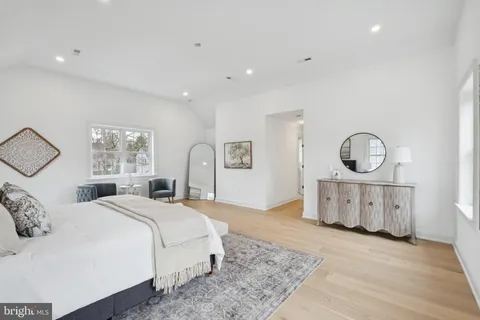 a bedroom with a large bed and a dresser