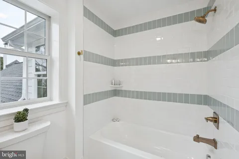 a bathroom with bathtub and shower