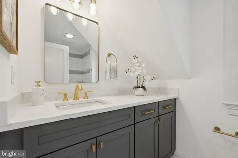 a bathroom with a double vanity sink and a mirror