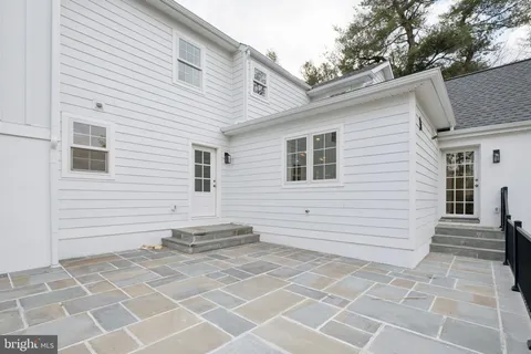 a view of a house with a white wall and a large window