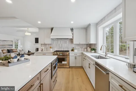 a kitchen with a sink a stove a refrigerator and a stove top oven