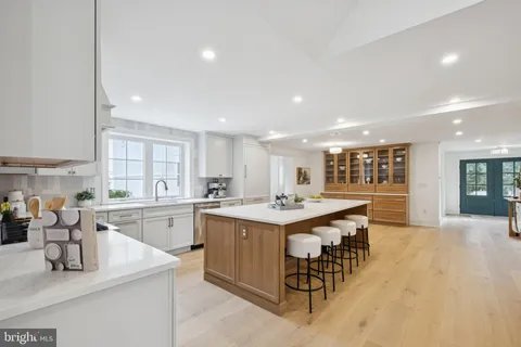 a kitchen with a sink and chairs