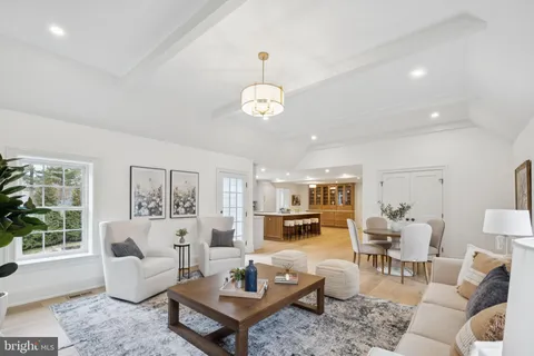 a living room with fireplace furniture and a large window