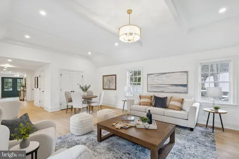 a living room with furniture or couches and a dining table with wooden floor