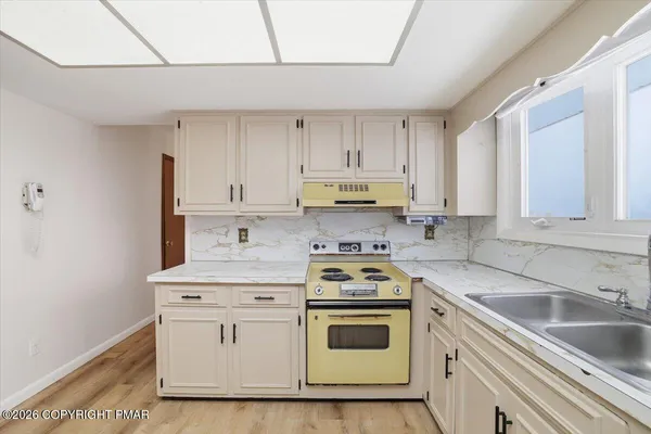a kitchen with cabinets appliances a sink and a counter top
