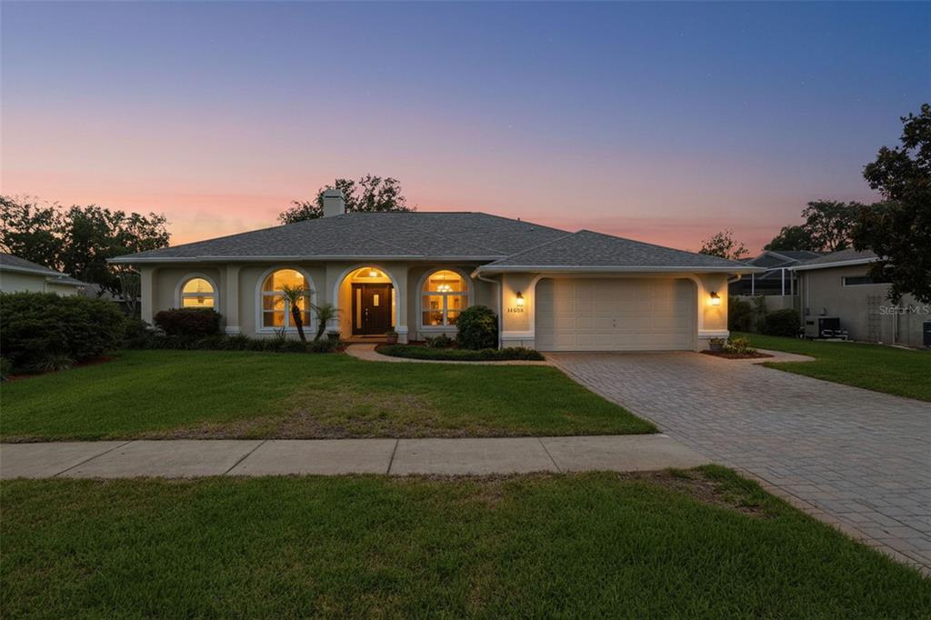 14228 Presteign Lane Spring Hill, FL 34609 - Photo 89 of 89 a front view of a house with a garden