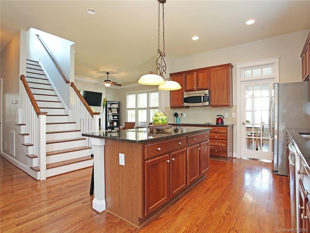 3542 Richard's Crossing Fort Mill, SC 29708 - Photo 13 of 24 a kitchen with stainless steel appliances granite countertop a refrigerator a stove and a wooden floors