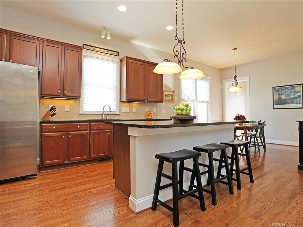 3542 Richard's Crossing Fort Mill, SC 29708 - Photo 10 of 24 a kitchen with granite countertop wooden floors furniture and appliances
