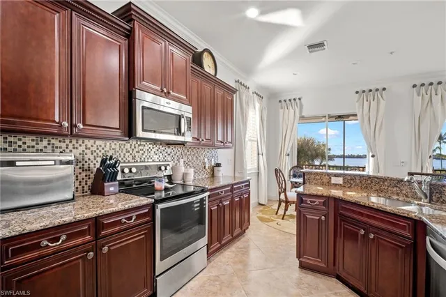 a kitchen with stainless steel appliances granite countertop wooden cabinets stove top oven and sink