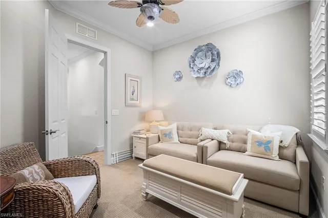 a living room with furniture a couch and a window