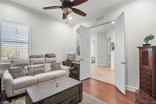 a living room with furniture and a wooden floor