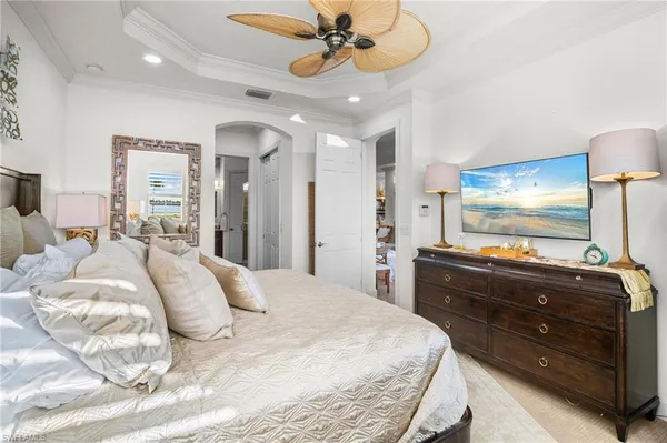 a bedroom with a bed and a chandelier