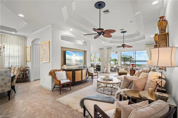 a living room with furniture and a chandelier