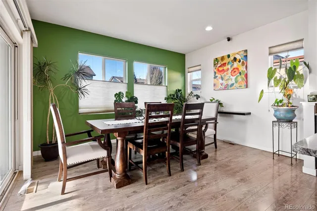 a view of a dining room with furniture window and wooden floor