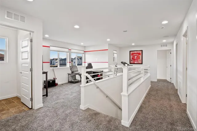 a view of a kitchen with refrigerator and window