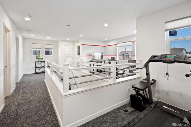 a large white kitchen with sink stove and a refrigerator