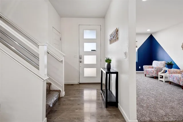 a view of a livingroom with furniture and a hallway