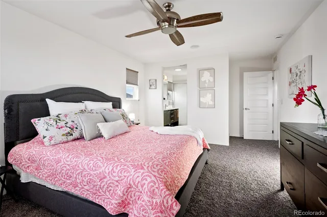 a bedroom with a bed and ceiling fan