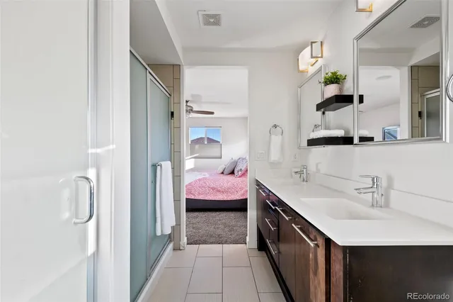 a en suite bathroom with a double vanity sink mirror and toilet