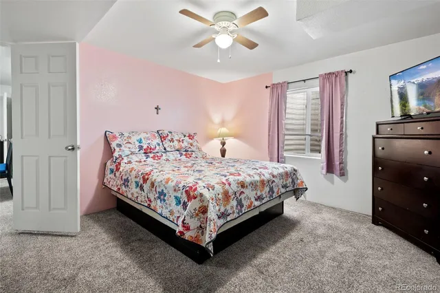 a bedroom with a bed and a tv