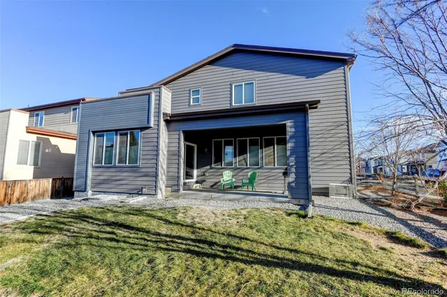 a view of house with yard and large tree in front of it