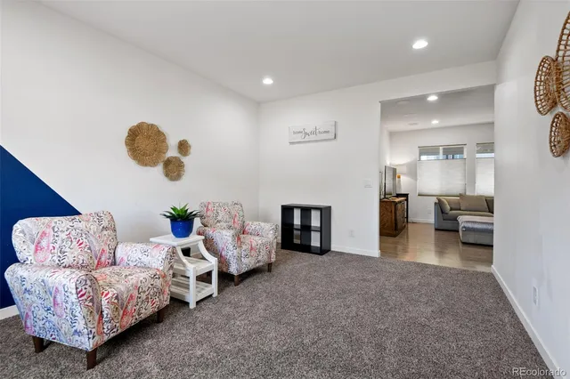 a living room with furniture and kitchen view