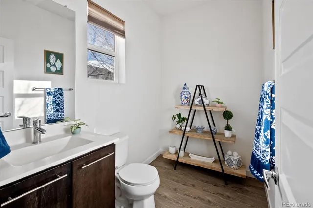 a bathroom with a sink toilet and a mirror