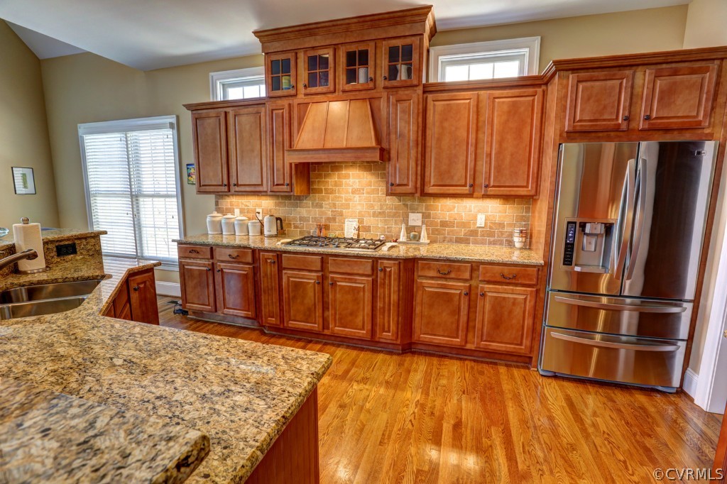 3724 Bircham Loop Midlothian, VA 23113 - Photo 8 of 24 a kitchen with stainless steel appliances granite countertop a refrigerator a sink dishwasher and wooden cabinets with wooden floor