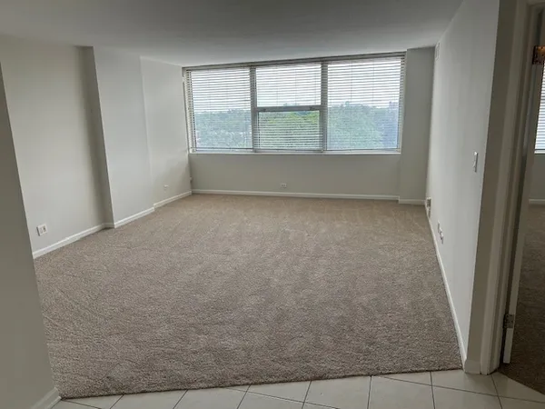 an empty room with a empty space and window