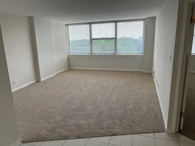 an empty room with a empty space and window