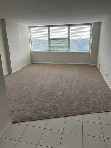 an empty room with windows and entrance