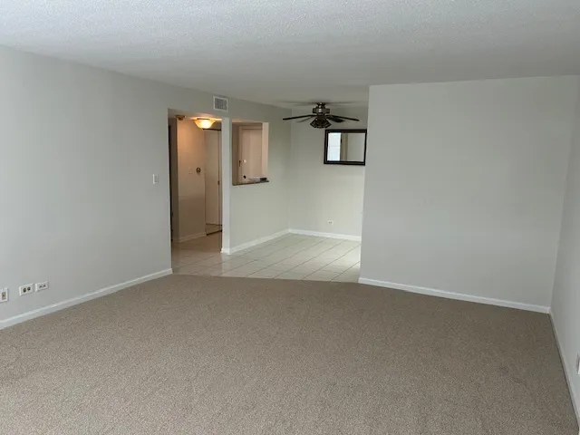 a kitchen with a sink a refrigerator and cabinets