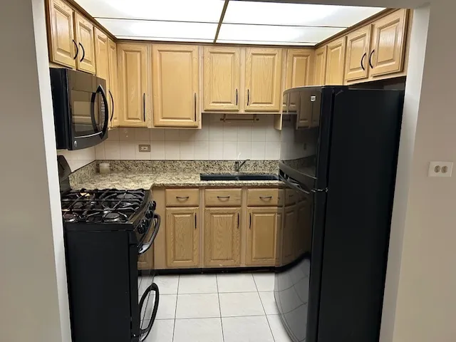 a kitchen with a stove and white cabinets