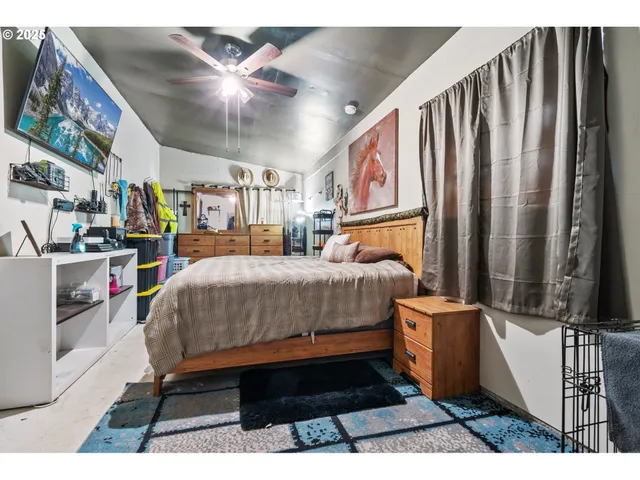 a bedroom with a bed and dresser with mirror