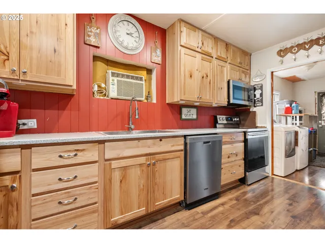 a kitchen with a stove a sink and a microwave