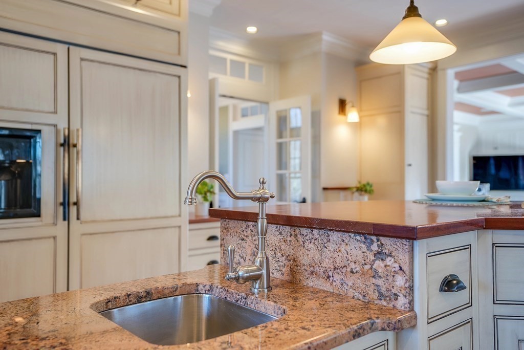 6 High Meadow Road Andover, MA 01810 - Photo 15 of 41 a kitchen with kitchen island granite countertop a sink and a refrigerator