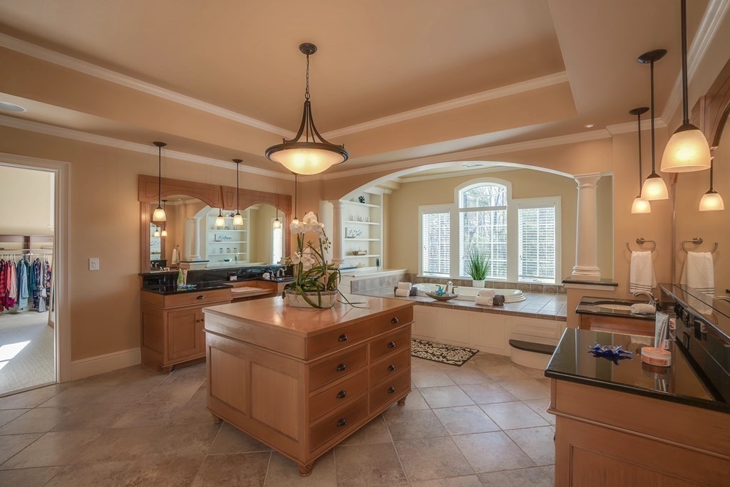 6 High Meadow Road Andover, MA 01810 - Photo 30 of 41 a large kitchen with kitchen island a large counter space a sink stainless steel appliances and cabinets
