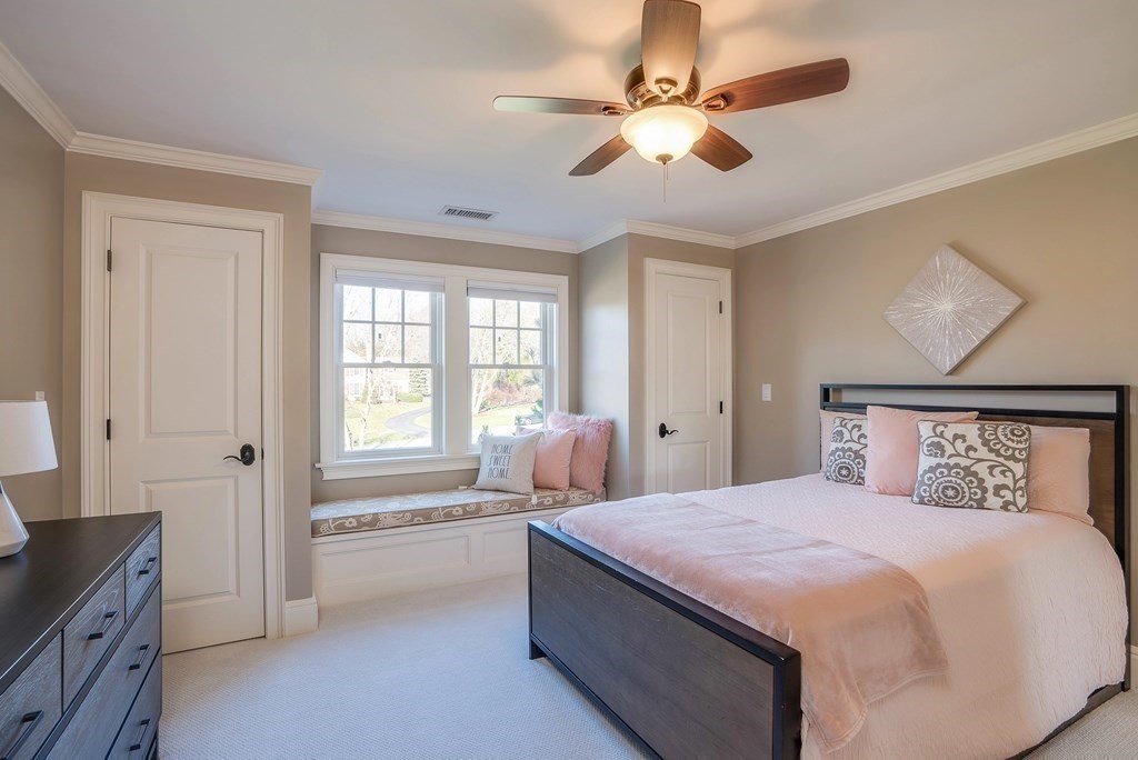 6 High Meadow Road Andover, MA 01810 - Photo 36 of 41 a bedroom with a large bed and a chandelier