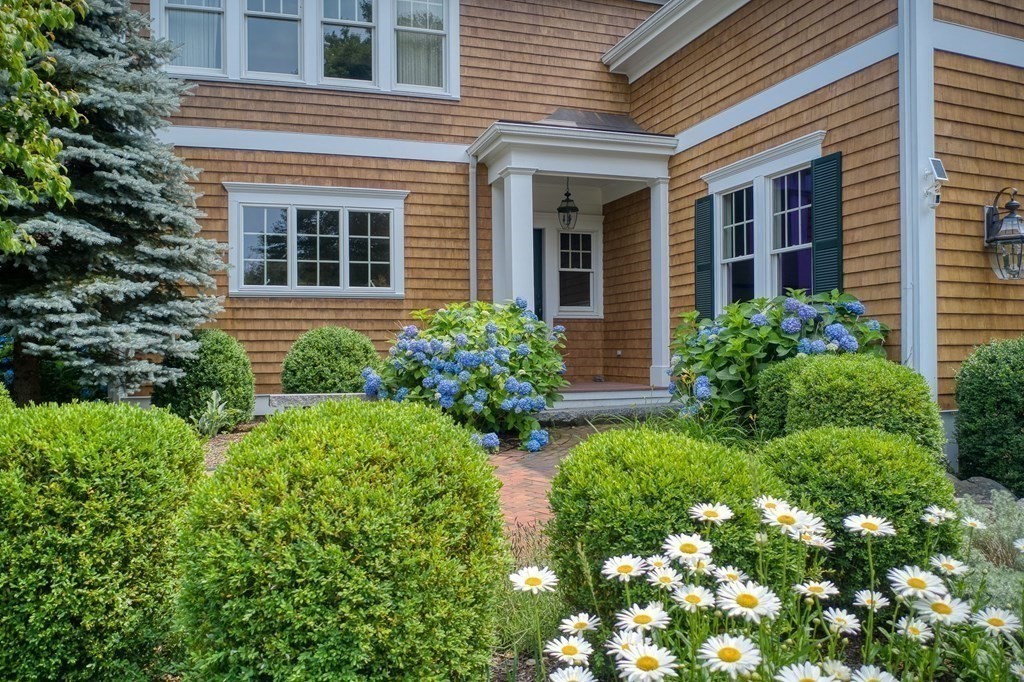 6 High Meadow Road Andover, MA 01810 - Photo 8 of 41 a view of a house with brick walls and flower plants