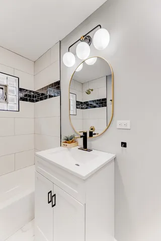a bathroom with a sink a mirror and vanity