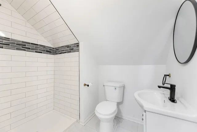a bathroom with a toilet and shower