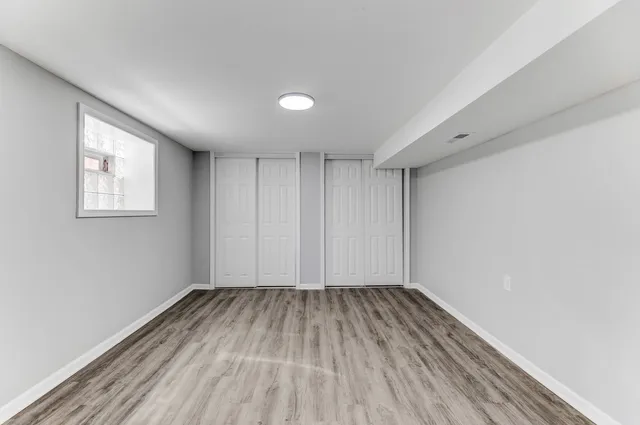 a view of room with window and wooden floor