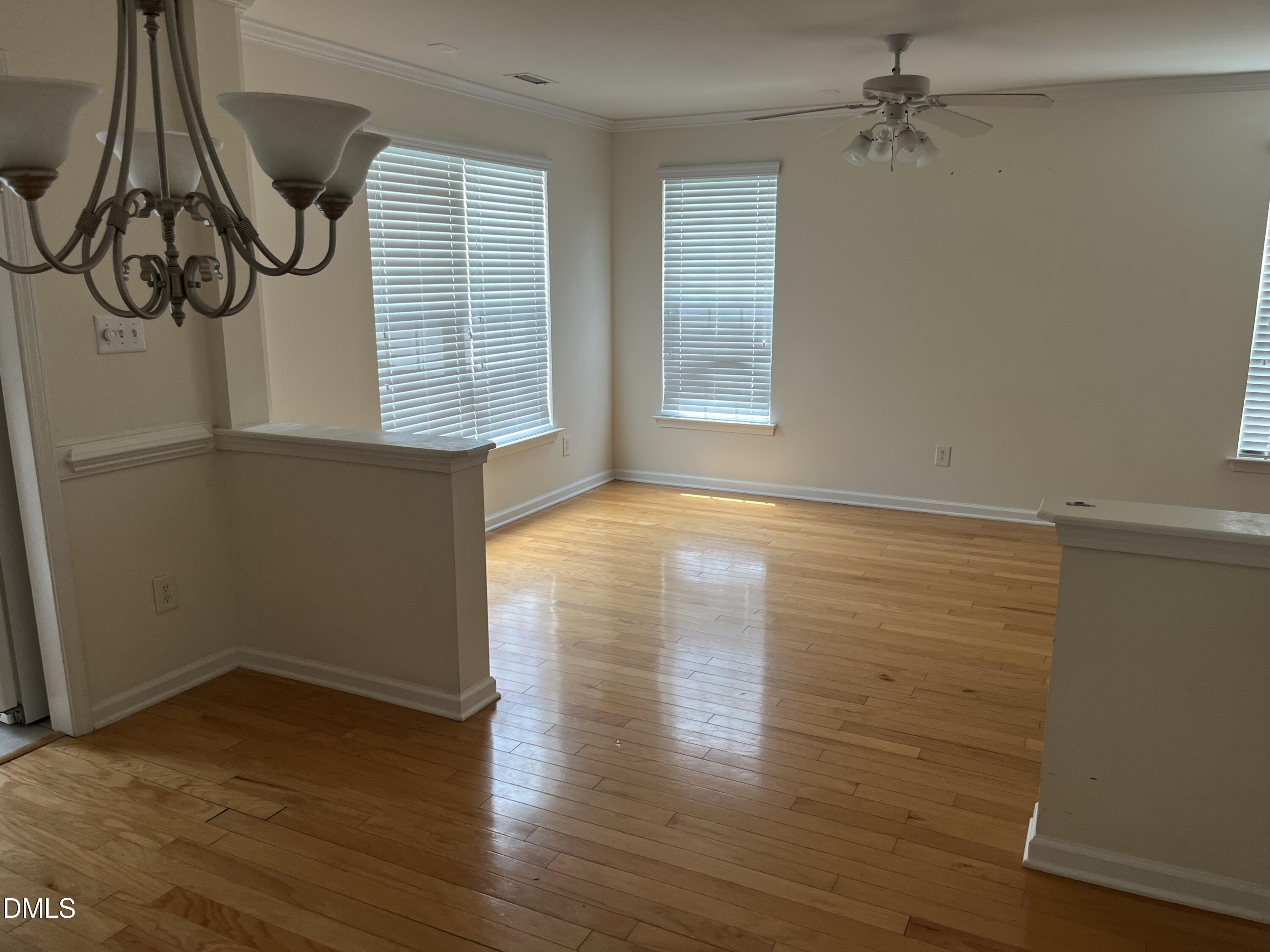 9827 Grettle Court Raleigh, NC 27617 - Photo 5 of 10 a view of a room with wooden floor and windows
