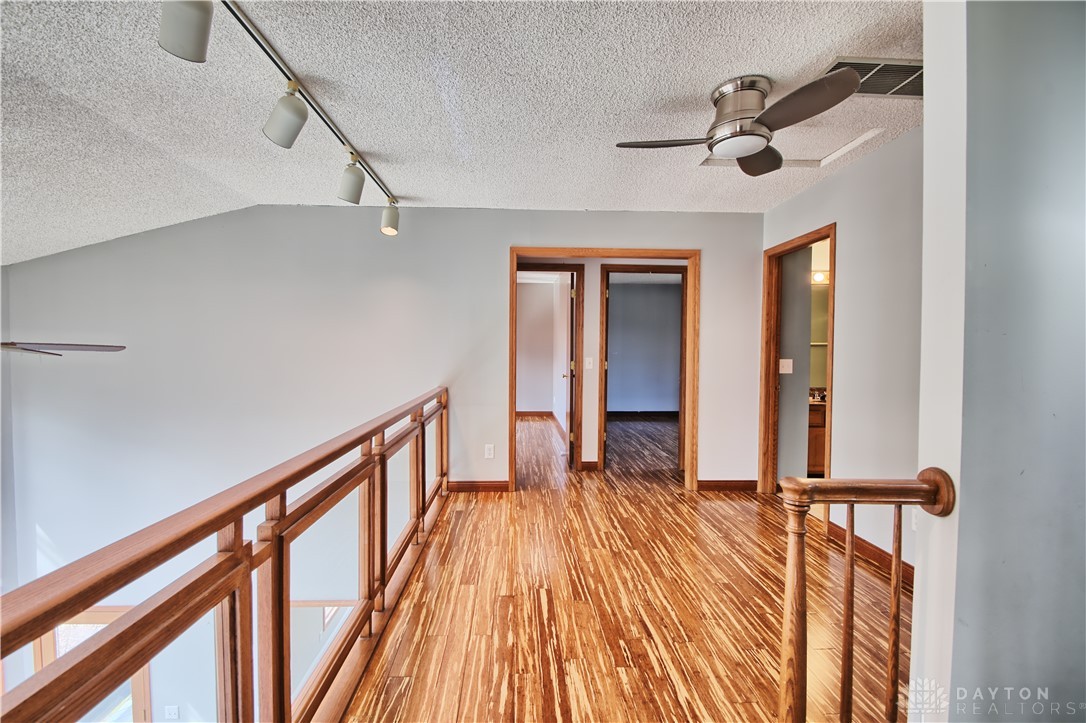 8711 Nicole Lane Springboro, OH 45066 - Photo 31 of 87 This airy hallway features striking hardwood floors and open railing.