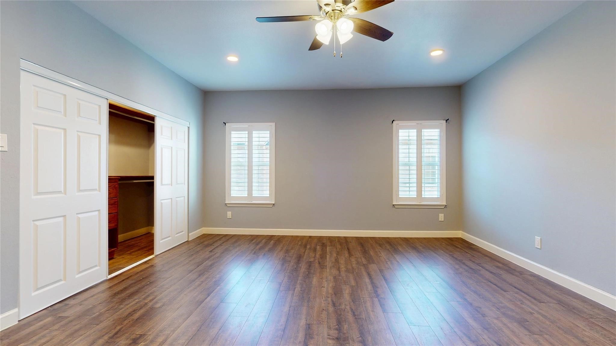 2984 Holly Hall Street Houston, TX 77054 - Photo 12 of 23 an empty room with wooden floor and windows