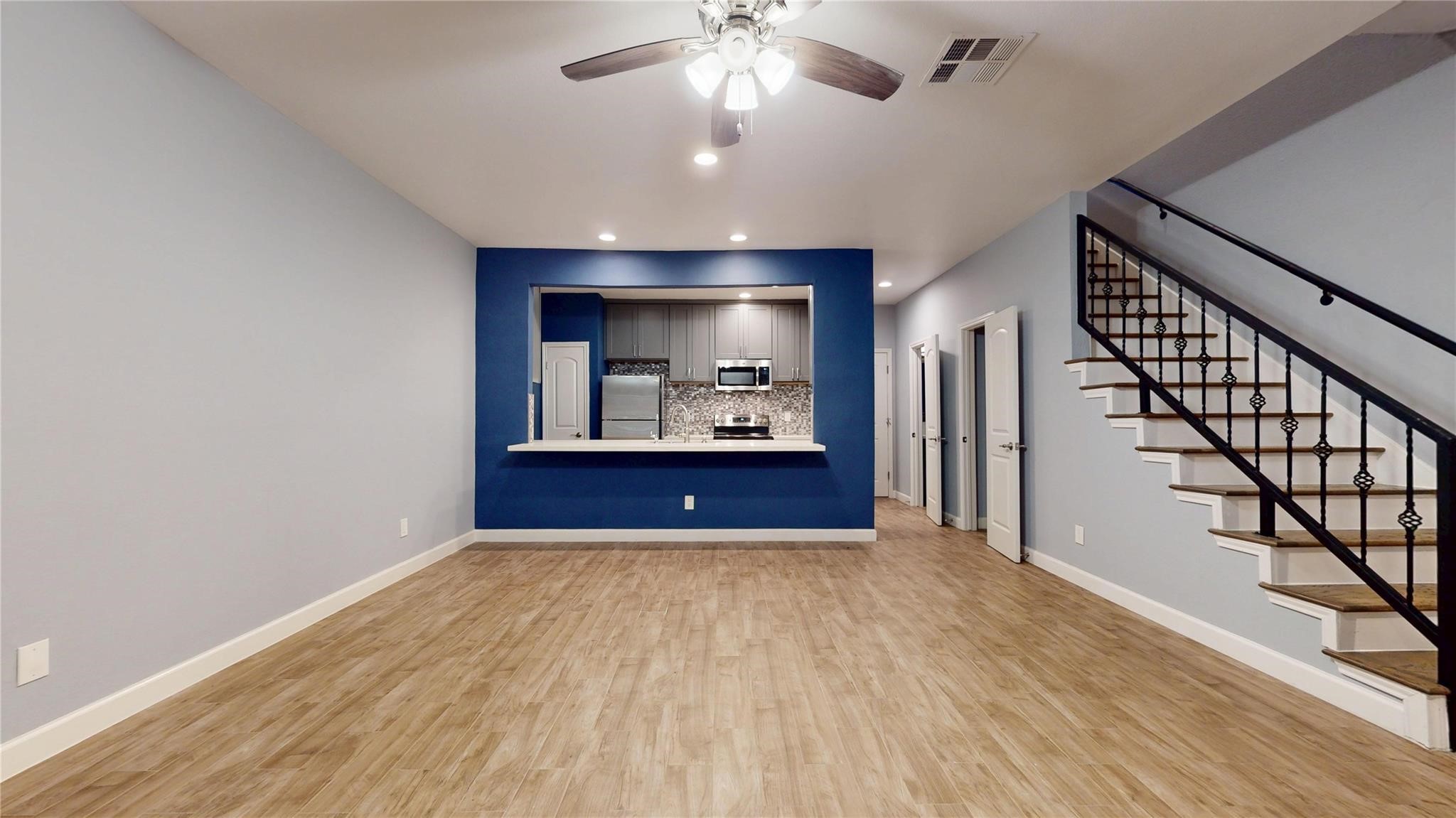 2984 Holly Hall Street Houston, TX 77054 - Photo 4 of 23 a view of a hallway with wooden floor and a chandelier