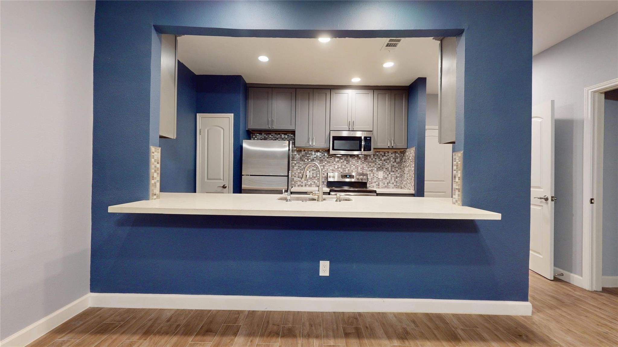 2984 Holly Hall Street Houston, TX 77054 - Photo 5 of 23 a kitchen with kitchen island stainless steel appliances a sink stove and refrigerator